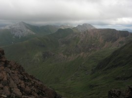 Green slopes below white and red tops